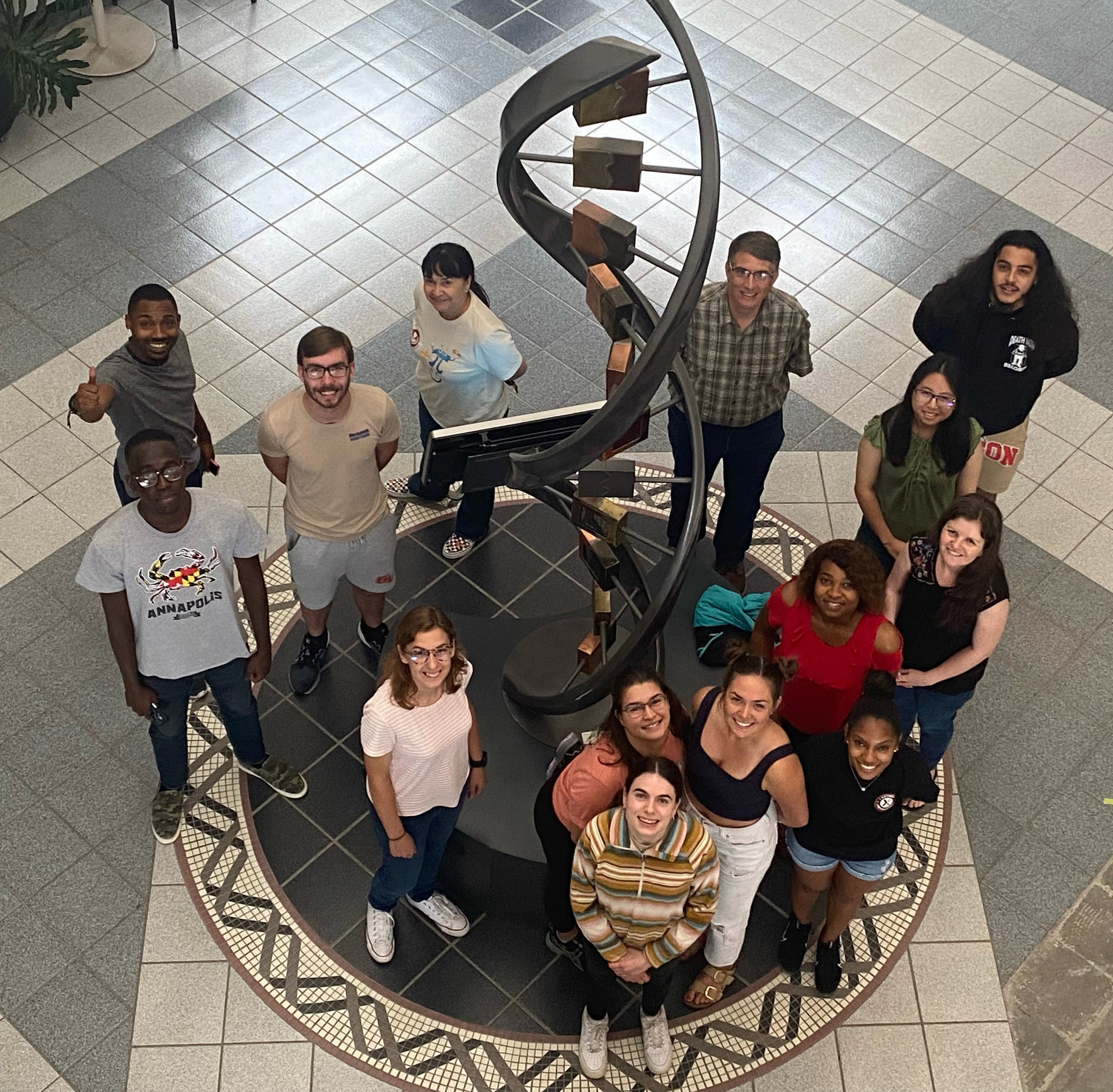 A group of people standing in the Beadle Center atrium