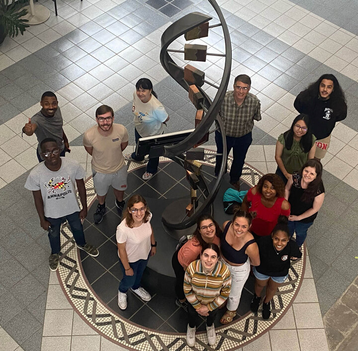 A group of people standing in the atrium of the Beadle Center.